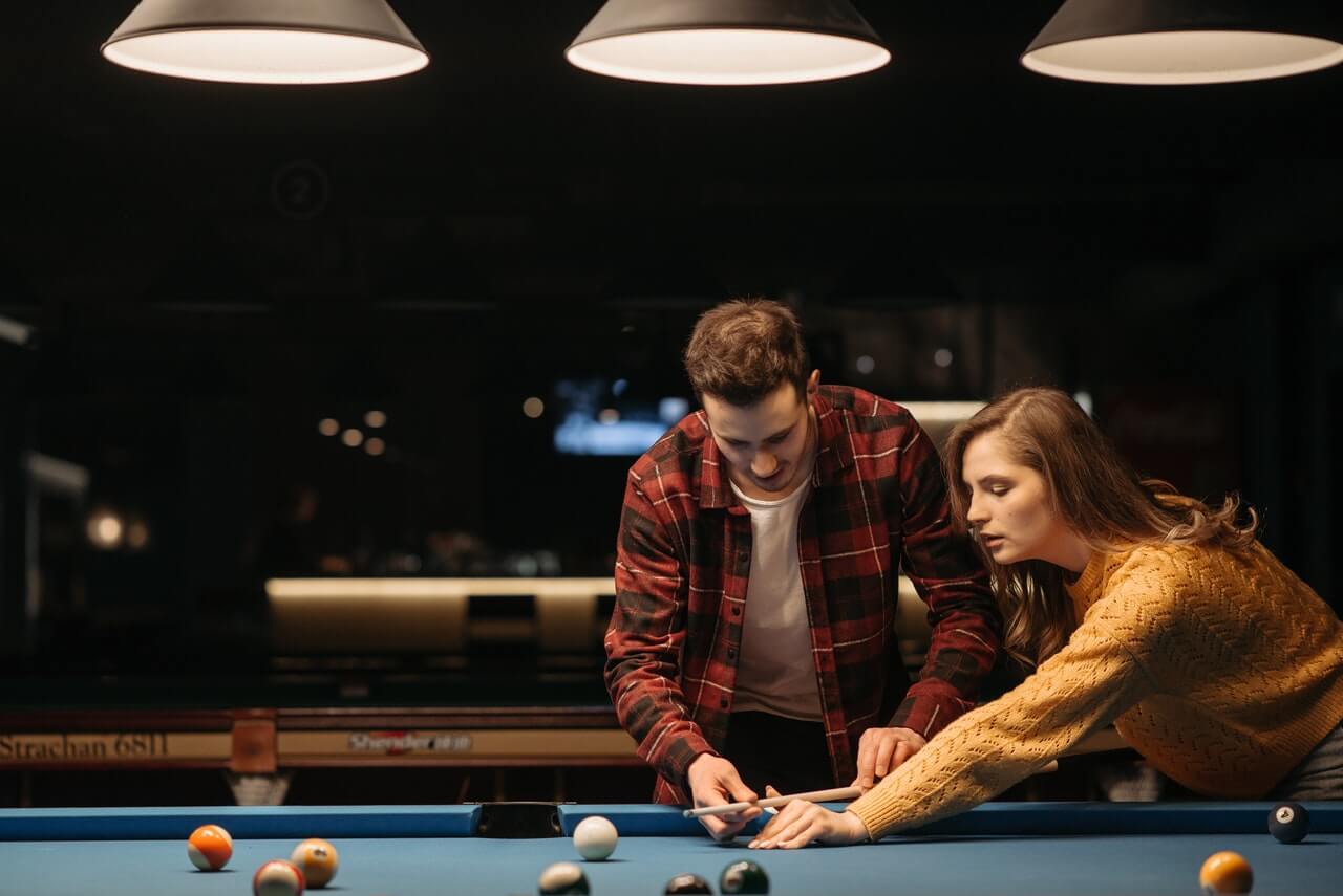 two people playing pool